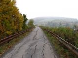 25.10.2009 - traťový úsek Jasenná - Ublo, dnes násep slouží jako silnice, na snímku je patrné místo, pod kterým je podjezd © Stanislav Plachý