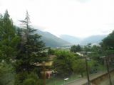 Pohled z vlaku na Gotthardbahn před stanicí Lamone-Cadempino na Lugano a jezero Lago di Lugano s horským masivem Monte Generosso v pozadí, 28.6.2014 © Jan Přikryl